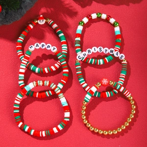 Detailed top view of handmade Christmas clay bead bracelets with Happy Christmas lettering