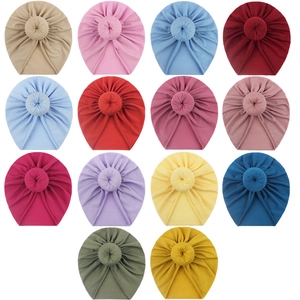 Collection of 14 colorful donut-style baby turban hats with top knot design