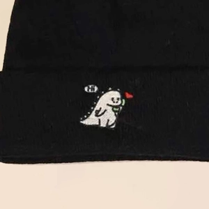 Winter black knit beanie with a cute small white dinosaur embroidery holding a red heart