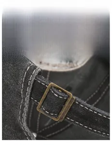 Detail of adjustable metal buckle and contrast stitching on vintage washed cotton cap