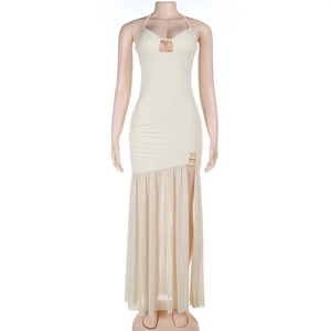 Detail of white halter dress featuring mesh patchwork, ruching, and a high slit design