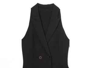 Detail of black double-breasted suit vest featuring a sharp lapel and smooth fabric