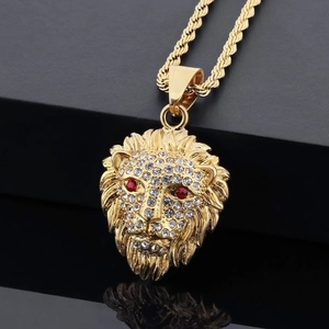 Close-up of a gold lion head pendant with sparkling rhinestones and a rope chain