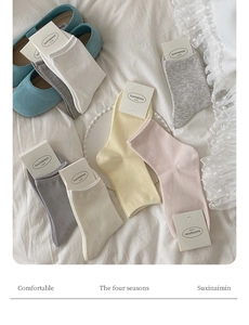 Flat lay of colorful cotton knit socks in soft macaron tones for women's daily comfort