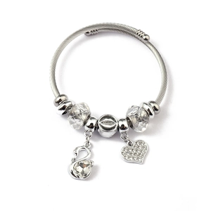 Detail view of silver braided bracelet with swan pendant and heart crystal charms