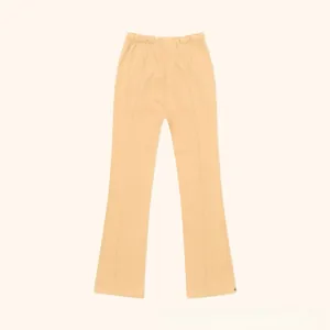 Detailed view of the high waist elastic band and front vertical seam on beige flared pants