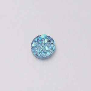 Detailed view of a 6mm blue round resin stone with sparkling druzy crystal texture