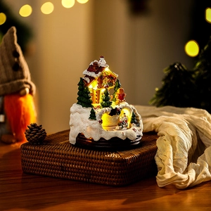 Detailed view of luminous resin Christmas music box featuring gingerbread house design
