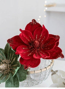 Macro shot of dark red velvet Christmas flower with sparkling red sequins and petals
