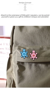 Detail of cute sky blue and pink cartoon turtle pins on a khaki canvas backpack