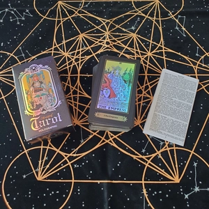 Macro view of 78-count holographic tarot cards set with packaging and guidebook