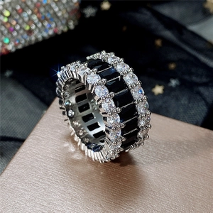 Macro shot of S925 silver ring featuring three rows of cubic zirconia and black gems