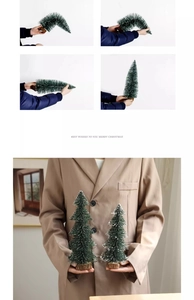 Detailed view of mini snow-flocked Christmas trees with natural wood bases