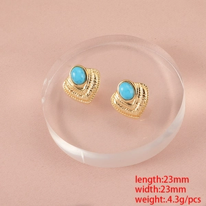Macro view of gold heart earrings with turquoise inlay and size dimensions 23mm x 23mm
