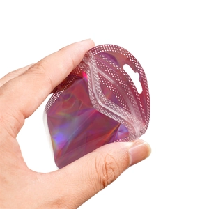 Close-up of a pink holographic resealable plastic bag with zipper and hang hole