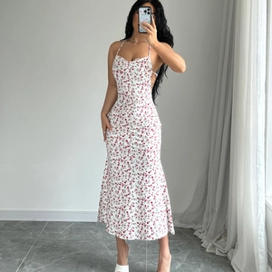 Close-up of white floral midi dress with pink flower print and elegant mermaid hem design