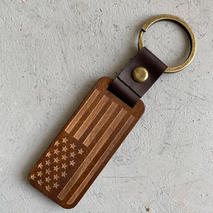 Macro view of vintage USA flag engraved wood and leather key ring pendant detail