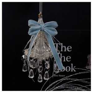 Macro detail of blue velvet bow and sparkling sequins on crystal chandelier ornament