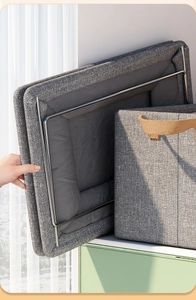 Close-up of foldable steel frame support inside grey fabric storage box and textile texture