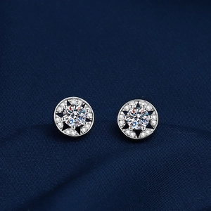 Close-up of geometric star earrings in silver with sparkling round-cut crystals