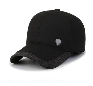 Detail shot of winter baseball cap with ear flaps and silver shield logo emblem