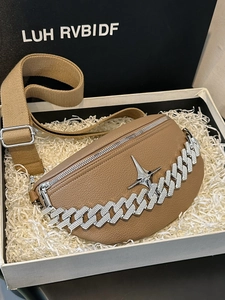 Detail of camel lychee leather waist bag with rhinestone chain in a gift box