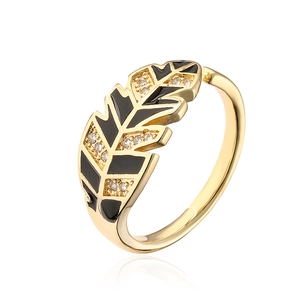 Golden leaf open ring with black enamel and sparkling zircon accents on white background