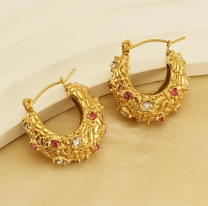 Detail of 18K gold plated C-shape hoop earrings with red and clear crystals