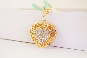 Close-up of gold heart keychain with sparkling rhinestone center and lobster clasp detail