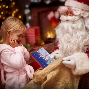 Christmas advent calendar 24-day countdown box given to a happy girl near a tree