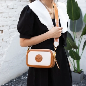 Vintage crossbody bag with wide printed strap and brown faux leather contrast