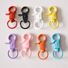 Matrix display of colorful rotating lobster clasps in eight vibrant paint finishes