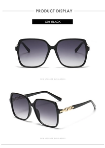 Detail of square sunglasses with black frames, gradient lenses and gold chain temples