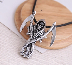 Macro detail of gothic grim reaper pendant with dual scythes and antique silver finish