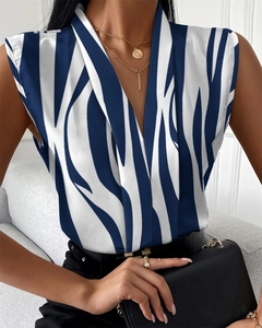 Detail of blue and white striped sleeveless V-neck satin shirt on a model with golden necklace