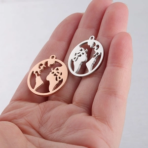 Detailed view of cutout world map pendants in rose gold and silver stainless steel