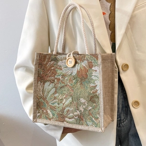Japanese style linen lunch bag with green floral tapestry pattern and rope handle