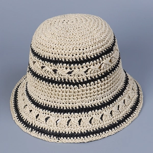Close-up of beige woven straw hat featuring parallel black stripes and breathable hollow knit