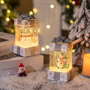 Luminous Christmas gift box lantern with snowman figure and glittering liquid inside