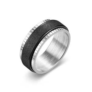 Detailed view of the black frosted texture and ribbed silver edges of a spinner ring.