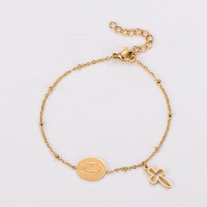 Close-up of gold stainless steel bracelet with round religious icon and cross charms