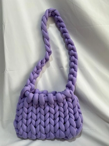 Detail of purple chunky knit bag showing handmade woven texture and soft puffy yarn