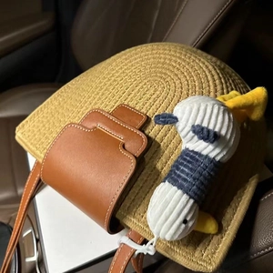 Handmade semi-circular woven cotton beach bag with leather flap and cute plush charm