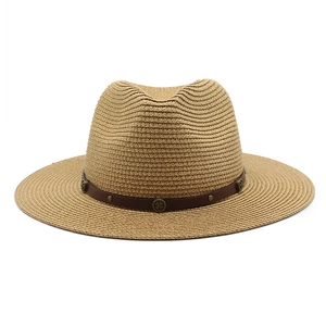 Detail of Panama straw hat featuring vintage leather band with bronze rivets and studs