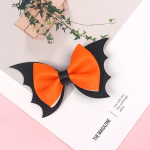 Detail of orange and black bat wing hair clip with litchi texture for Halloween party