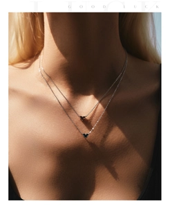 Artistic shadow view of double-layer S925 silver necklaces with red and blue heart stones