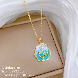 Detail of gold enamel pendant with blue sky pattern, pearl, and flower on jewelry box