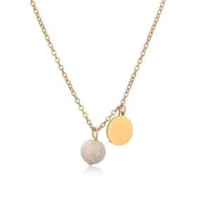 Detail of gold pendant necklace with flat metal disc and gray marble stone bead