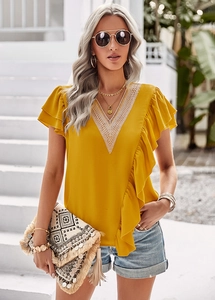 Detail of yellow V-neck blouse with white lace trim and feminine ruffled short sleeves