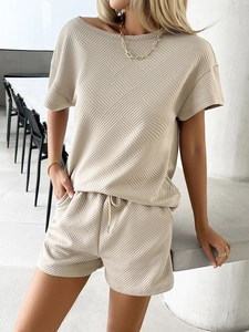 Close-up of beige short sleeve knit set with geometric texture and matching shorts